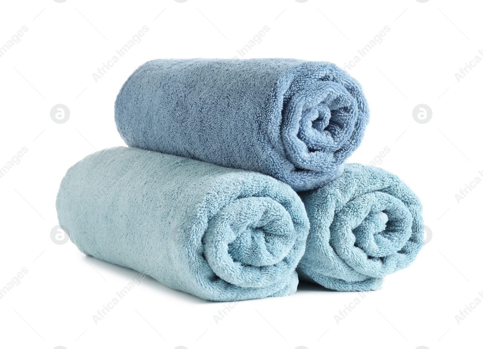 Photo of Rolled soft terry towels on white background