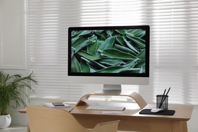 Comfortable workplace with modern computer near window in room