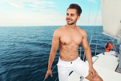 Photo of Young man resting on yacht at sea