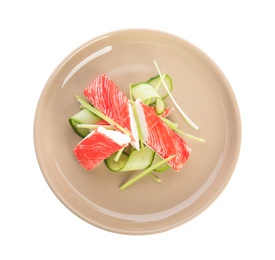 Plate with fresh crab sticks and cucumber isolated on white, top view