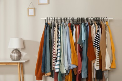 Rack with stylish clothes indoors. Fast fashion