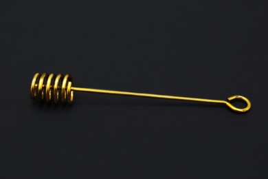 Elegant gold honey dipper on black background