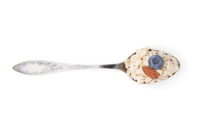 Photo of Spoon with oatmeal, blueberry and almond isolated on white, top view