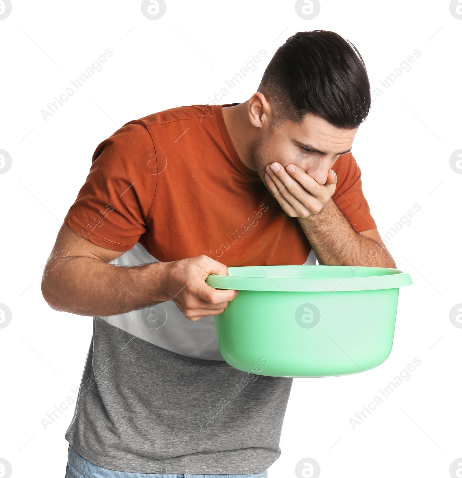 Photo of Man with basin suffering from nausea on white background. Food poisoning