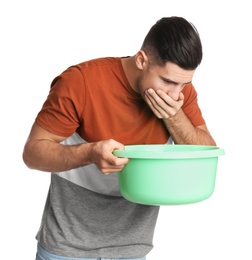 Man with basin suffering from nausea on white background. Food poisoning