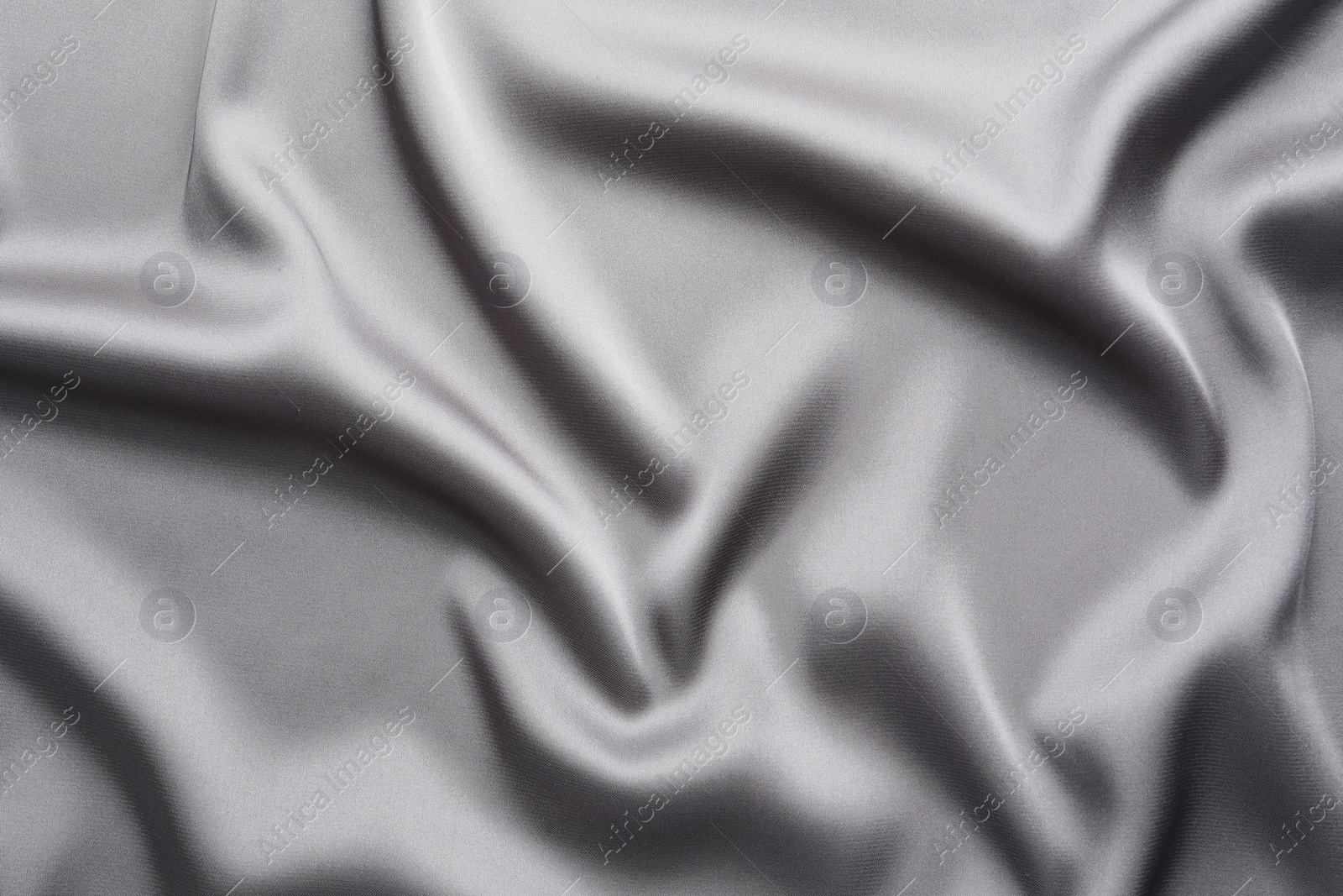 Photo of Texture of beautiful light grey silk fabric as background, closeup