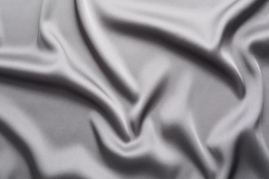 Texture of beautiful light grey silk fabric as background, closeup