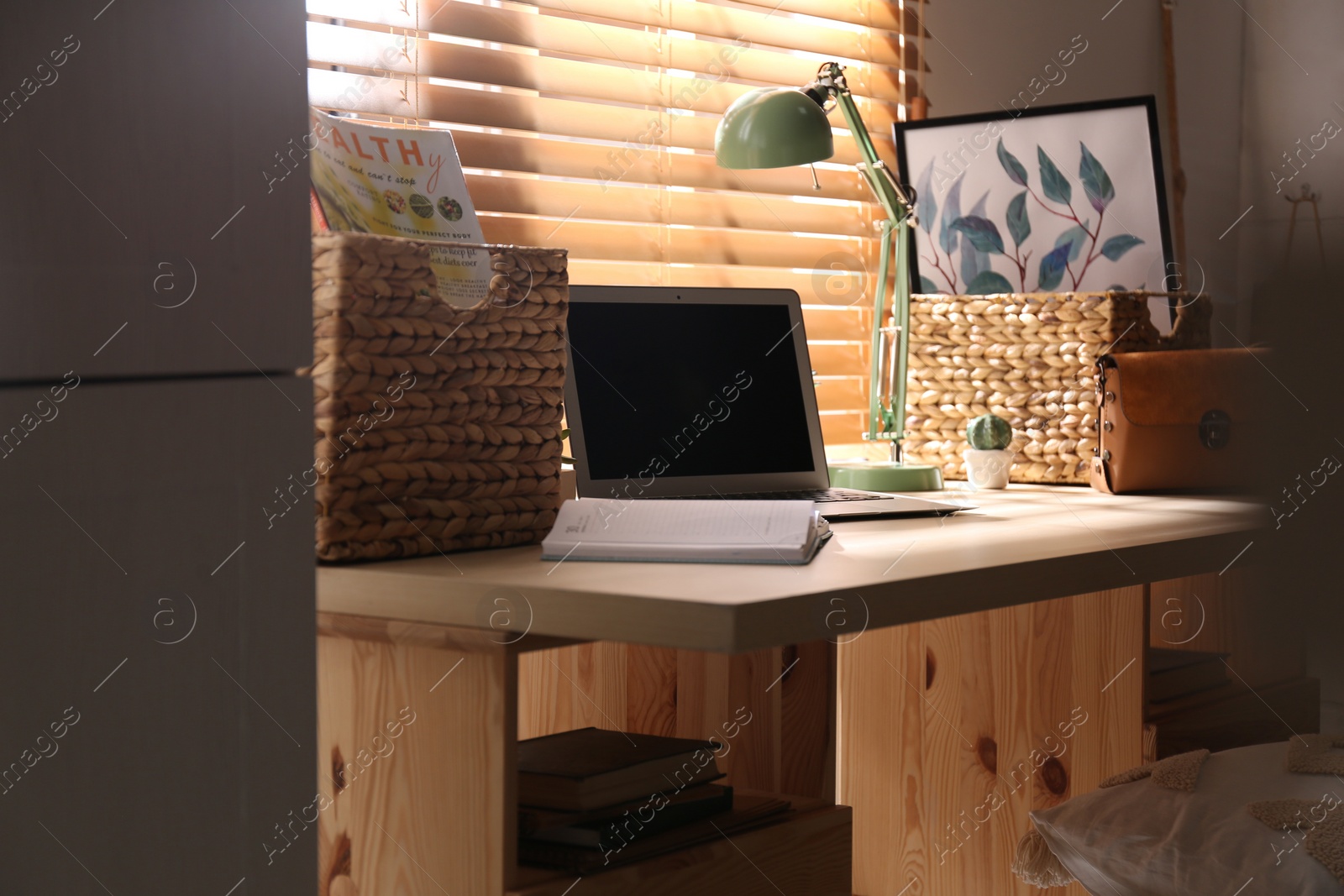 Photo of Comfortable workplace with laptop near window at home