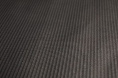 Photo of Dark grey corrugated sheet of cardboard as background, closeup