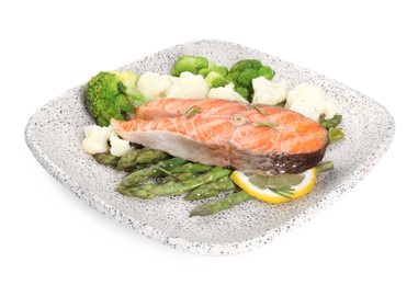 Photo of Plate of tasty grilled salmon, lemon and vegetables isolated on white