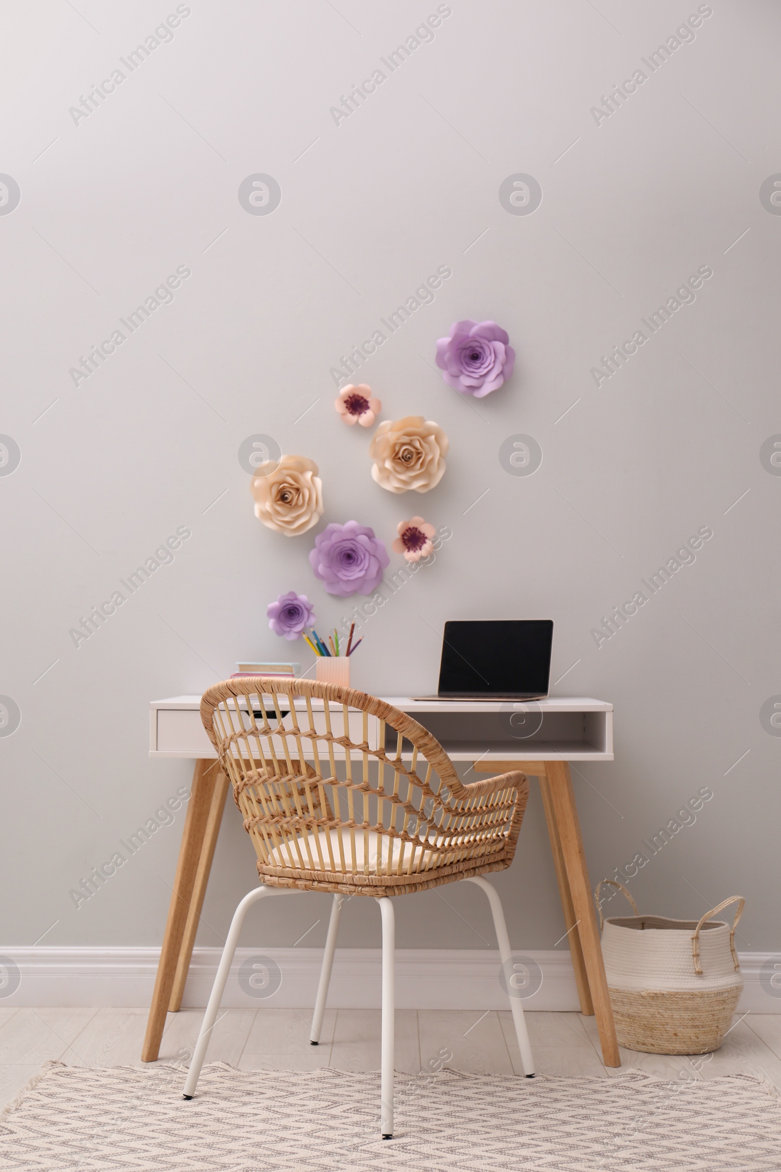 Photo of Stylish room interior with floral decor and modern furniture