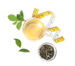 Photo of Diet herbal tea, measuring tape, dry and fresh leaves on white background, top view