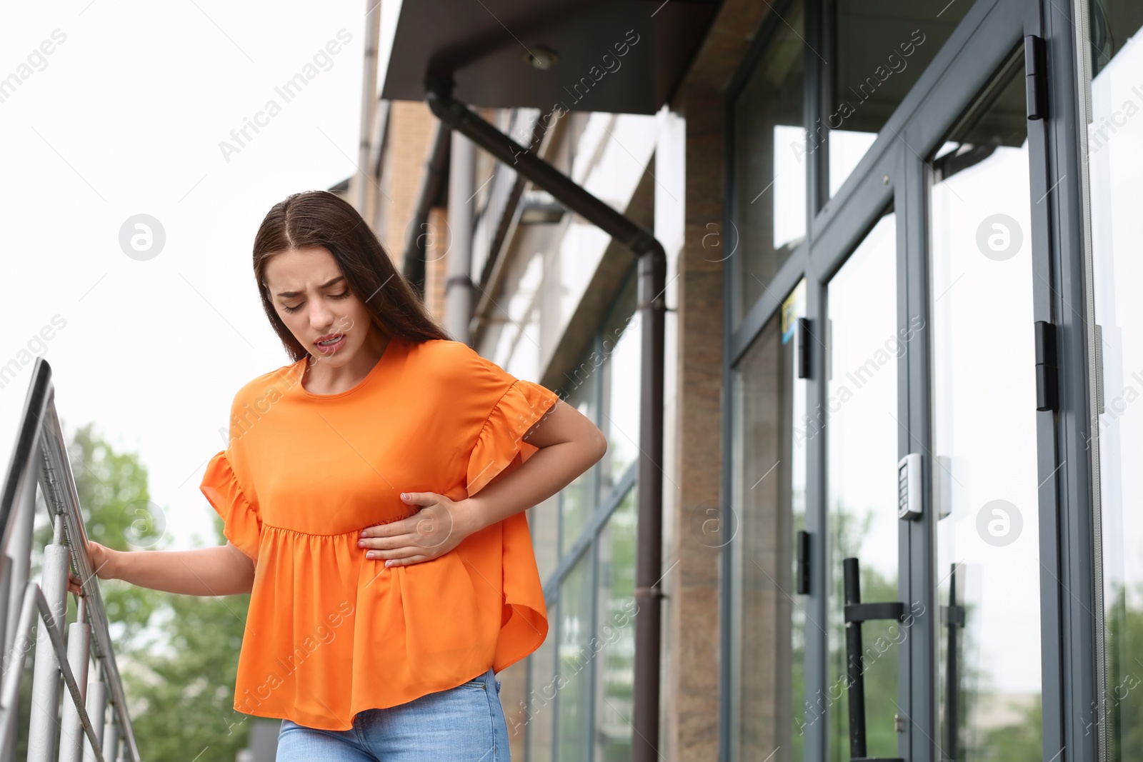 Photo of Young woman having chest pain outdoors. Heart attack