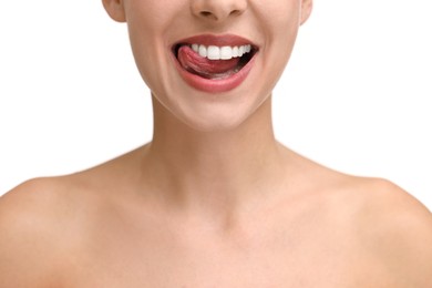 Photo of Woman with beautiful lips licking her teeth on white background, closeup