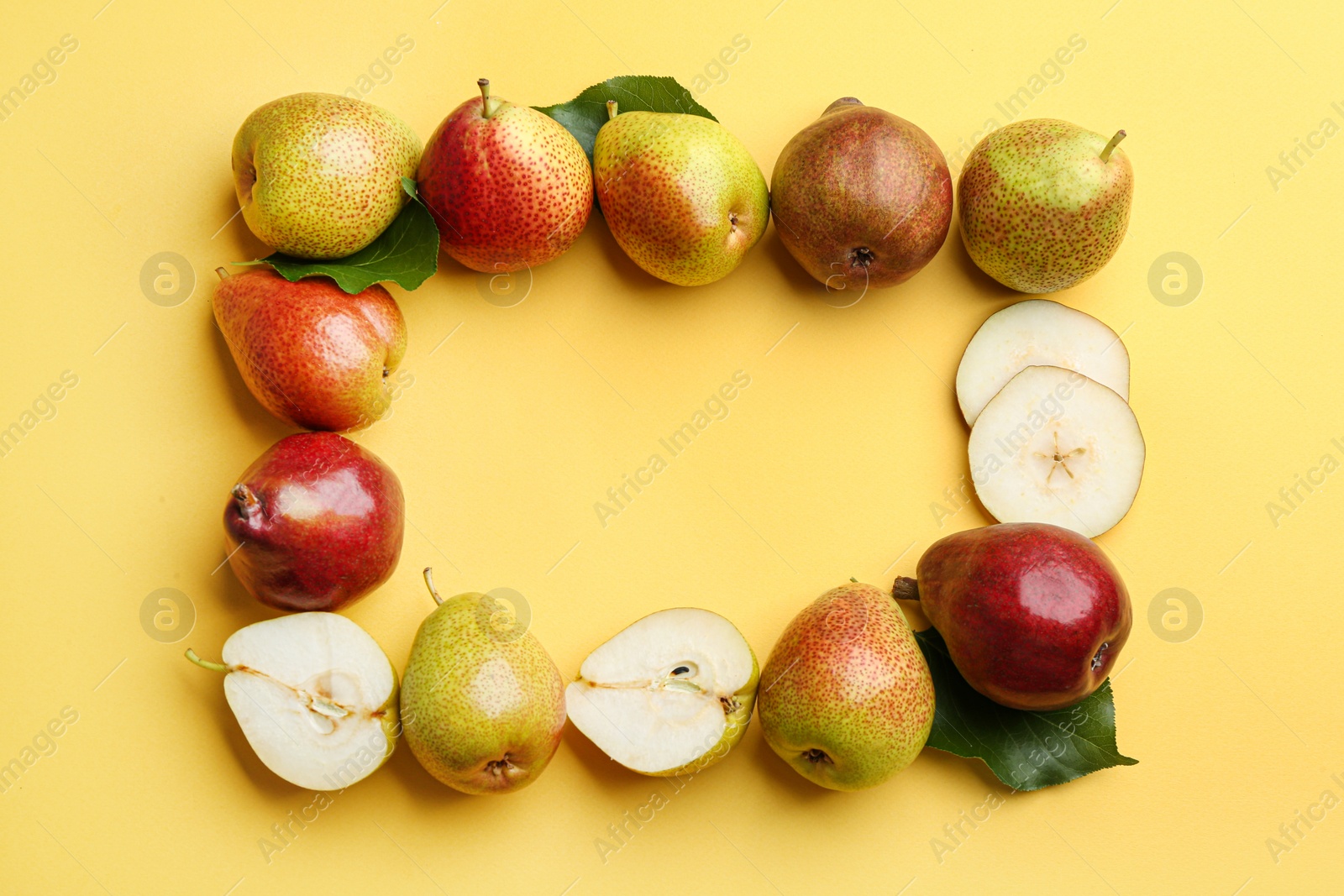 Photo of Ripe juicy pears on yellow background, flat lay. Space for text