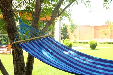 Photo of Comfortable blue hammock outdoors on sunny day