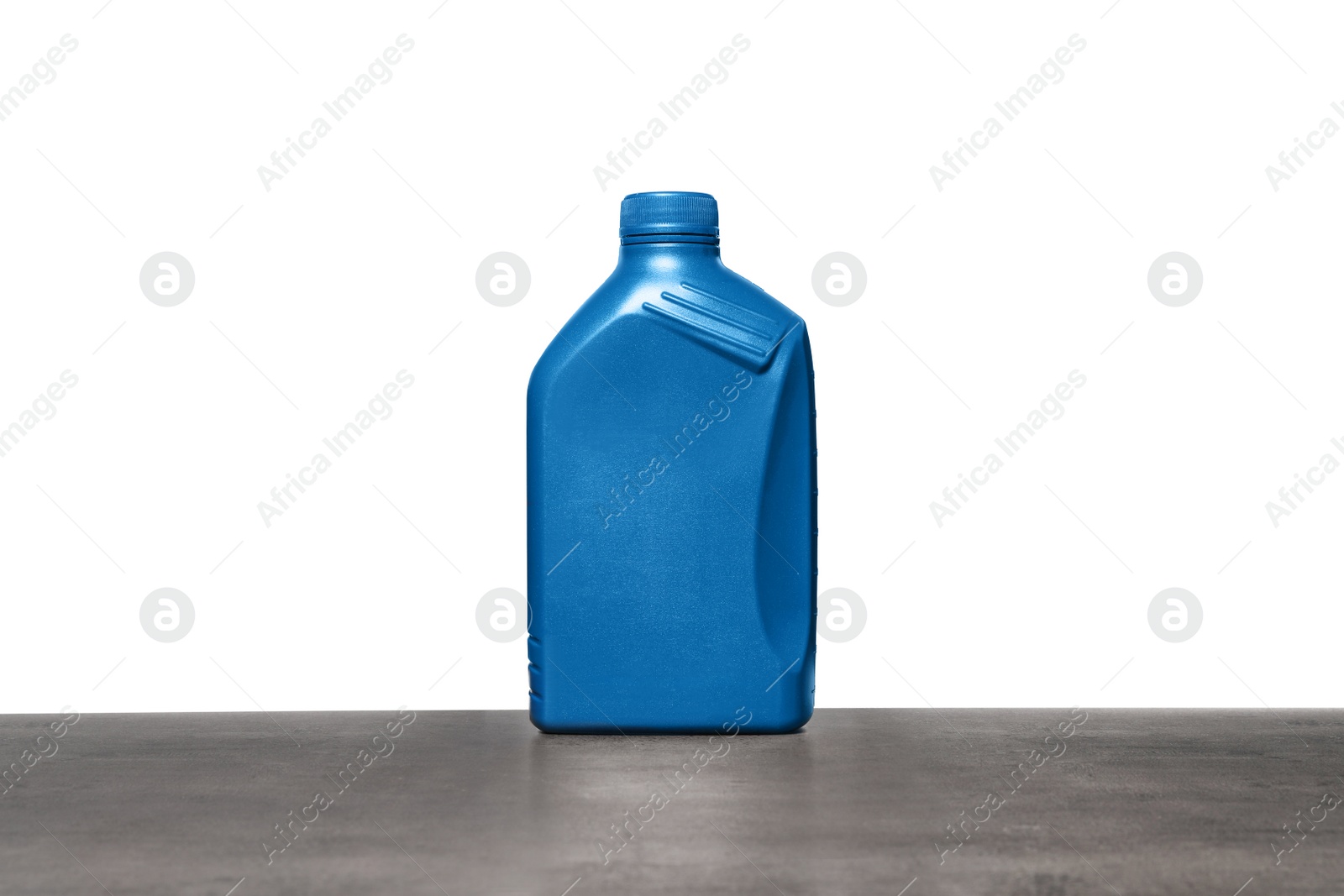 Photo of Motor oil in blue container on grey table against white background
