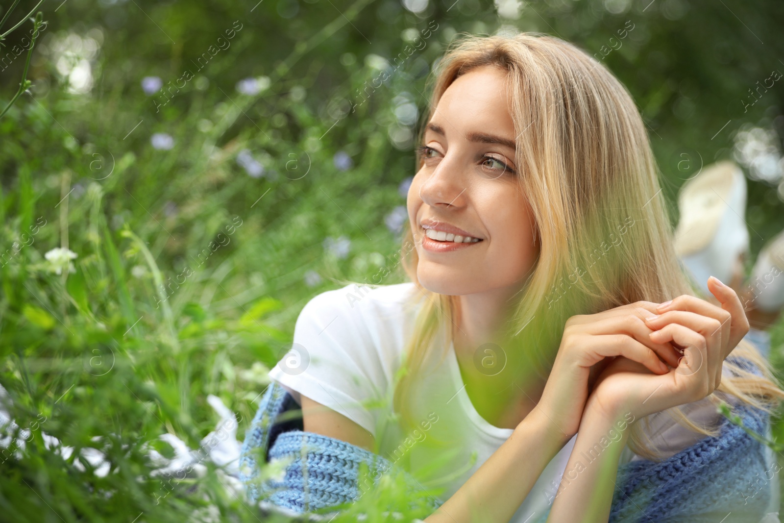 Photo of Portrait of beautiful young woman on green grass in park