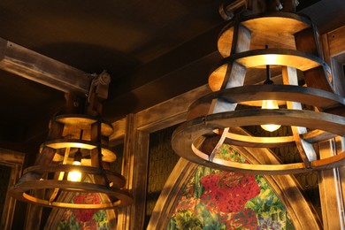 Stylish pendant lamps on ceiling in hotel room