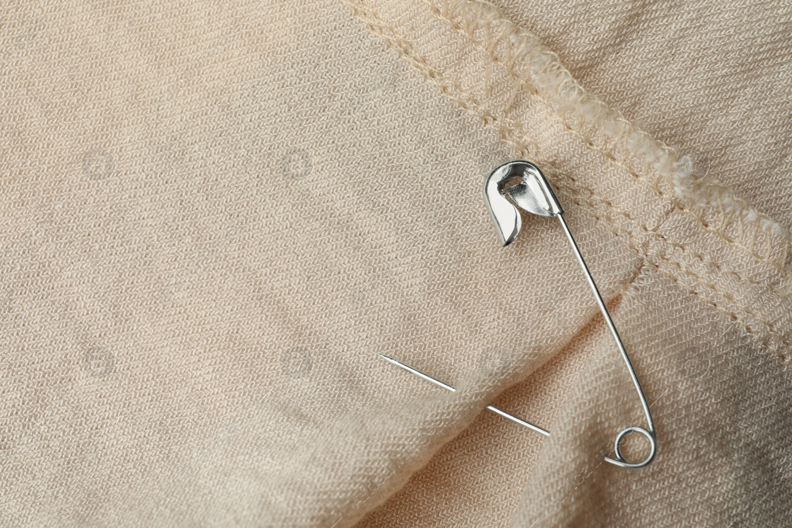 Photo of Top view of metal safety pin on clothing