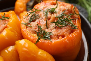 Photo of Tasty stuffed peppers with dill in pan, closeup