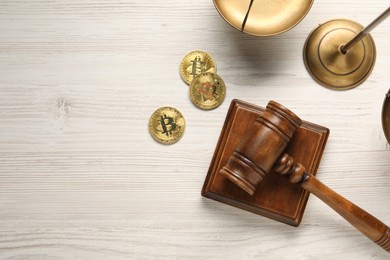 Photo of Law concept. Gavel, scales and bitcoins on white wooden table, flat lay. Space for text
