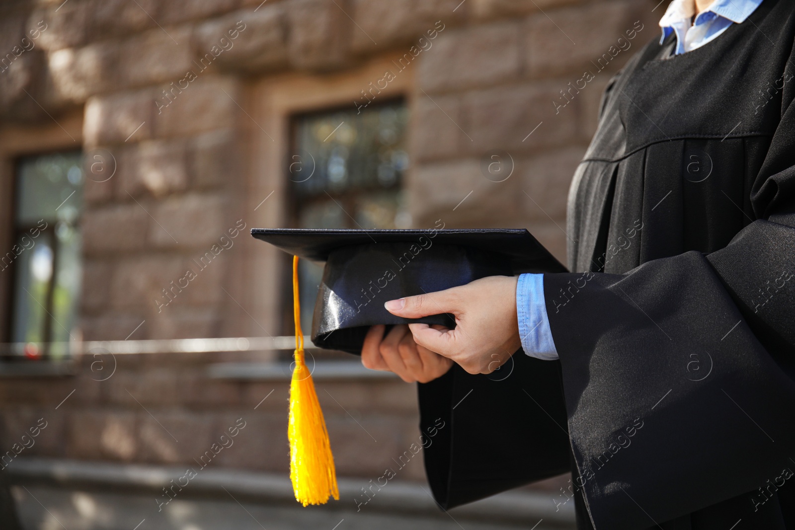 Photo of Female student with graduation hat outdoors, closeup