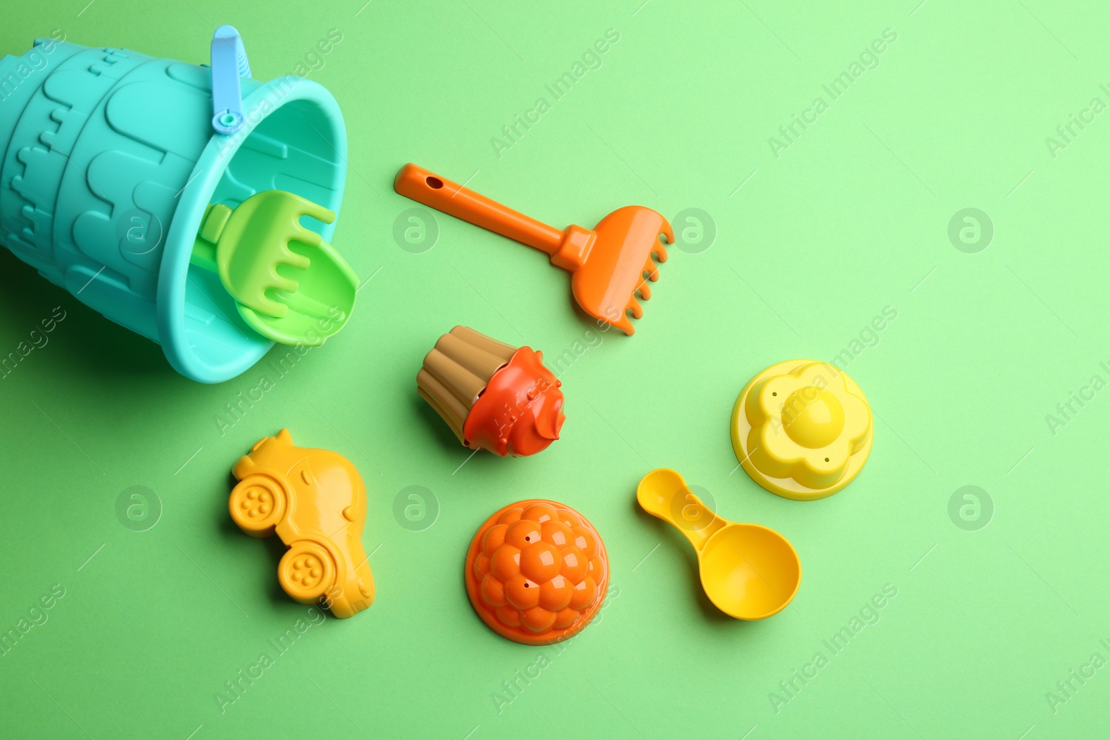 Photo of Flat lay composition with bright beach toys on color background