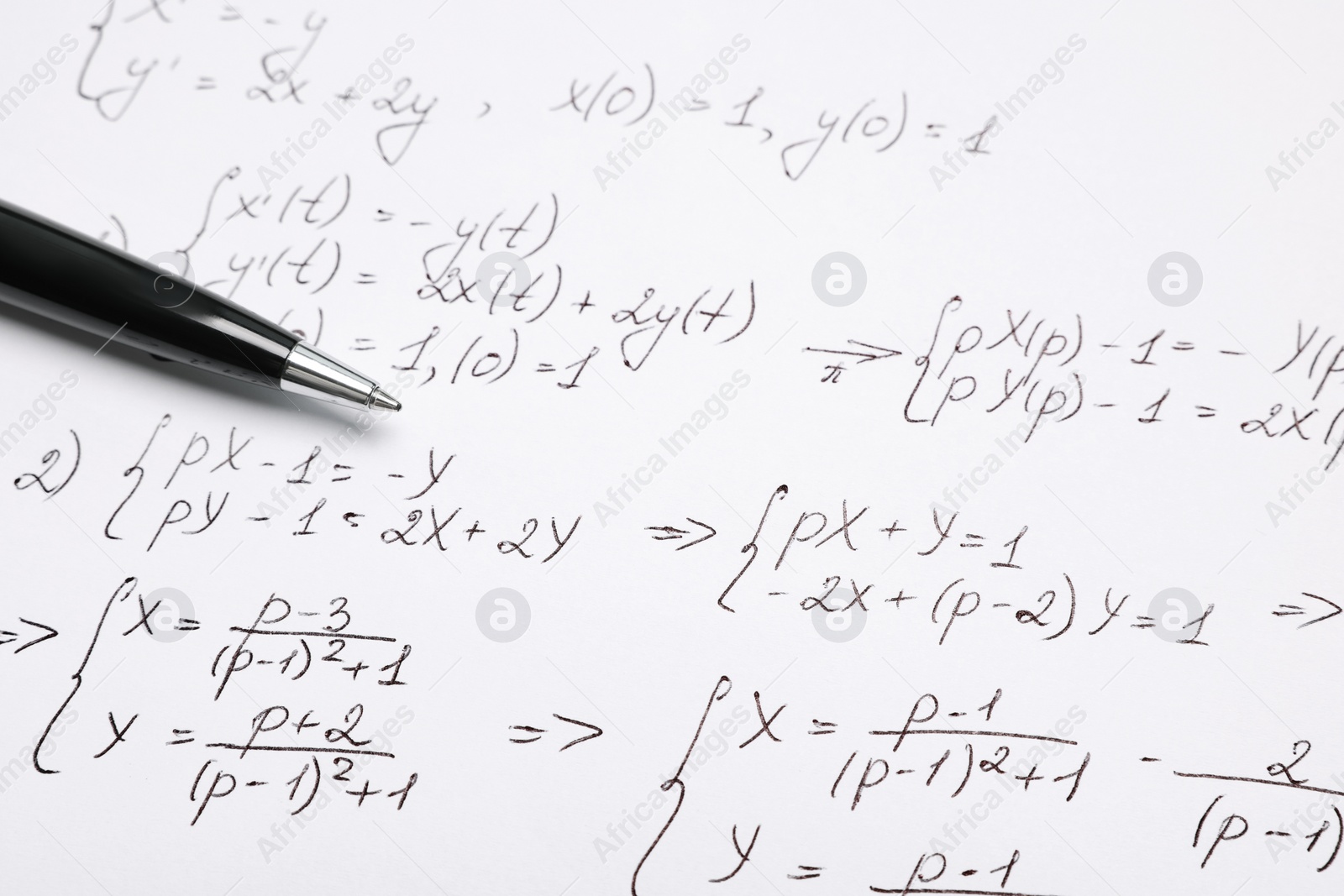 Photo of Sheet of paper with mathematical formulas and pen, closeup