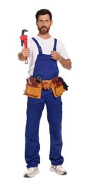 Professional plumber with pipe wrench and tool belt on white background