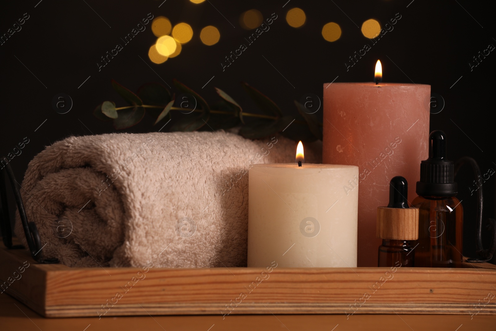 Photo of Beautiful composition with different spa products on table against blurred lights, closeup