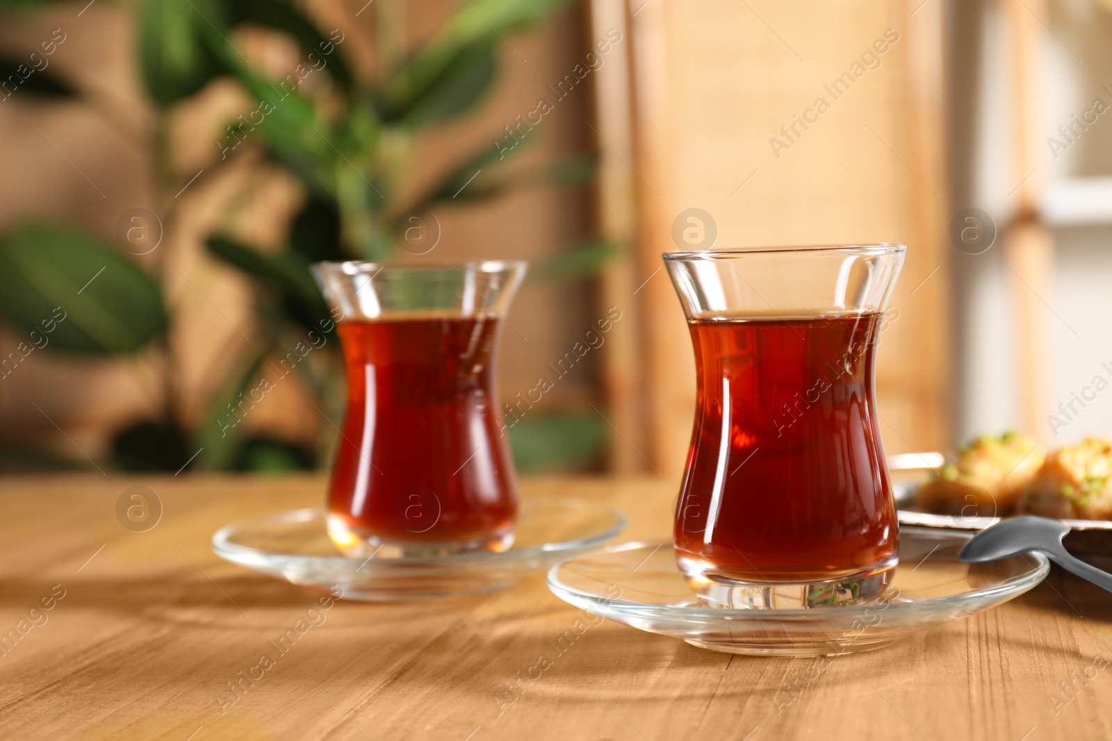 Photo of Traditional Turkish tea in glasses on wooden table