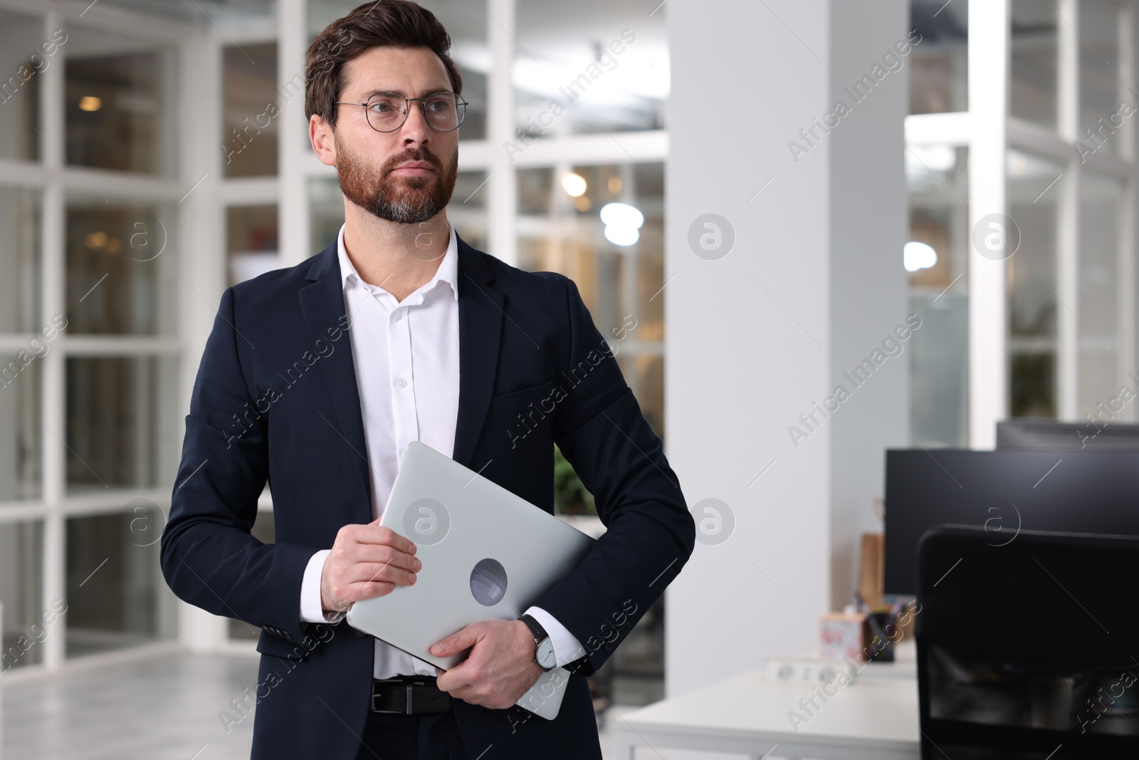 Photo of Portrait of handsome man with laptop in office, space for text. Lawyer, businessman, accountant or manager