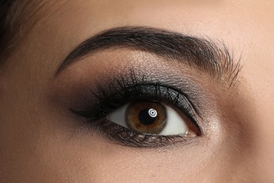 Photo of Young woman with evening makeup, closeup. Eye shadow product