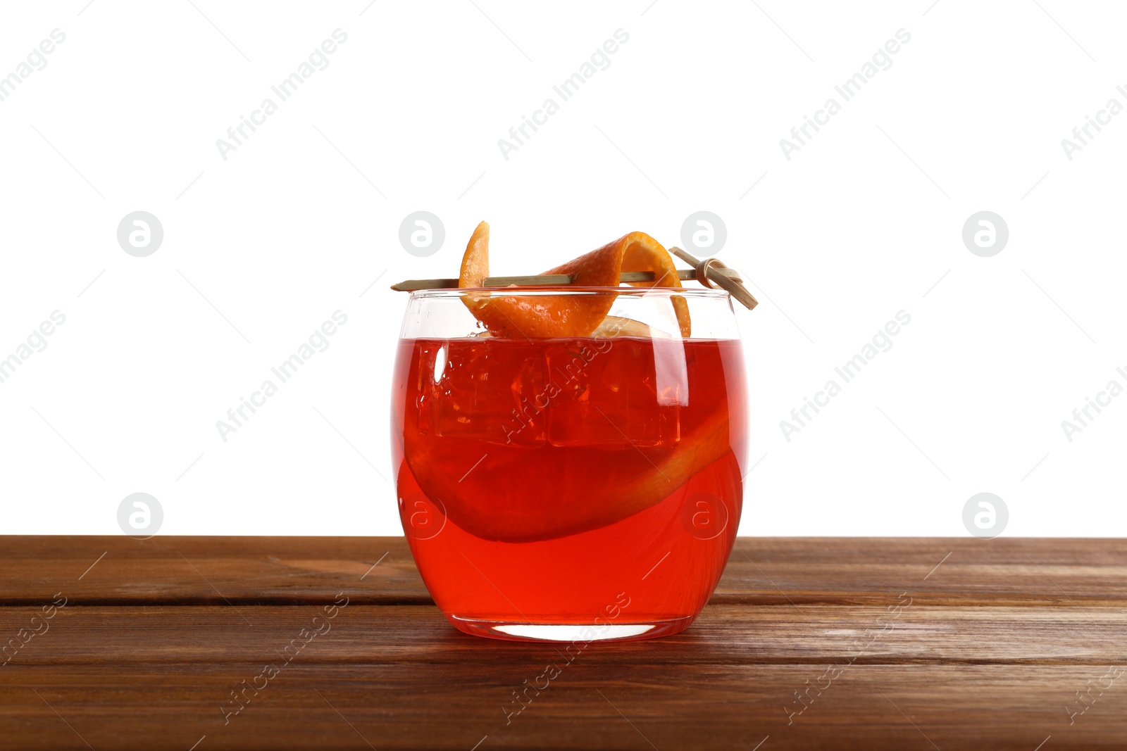 Photo of Aperol spritz cocktail and orange slices in glass on wooden table against white background