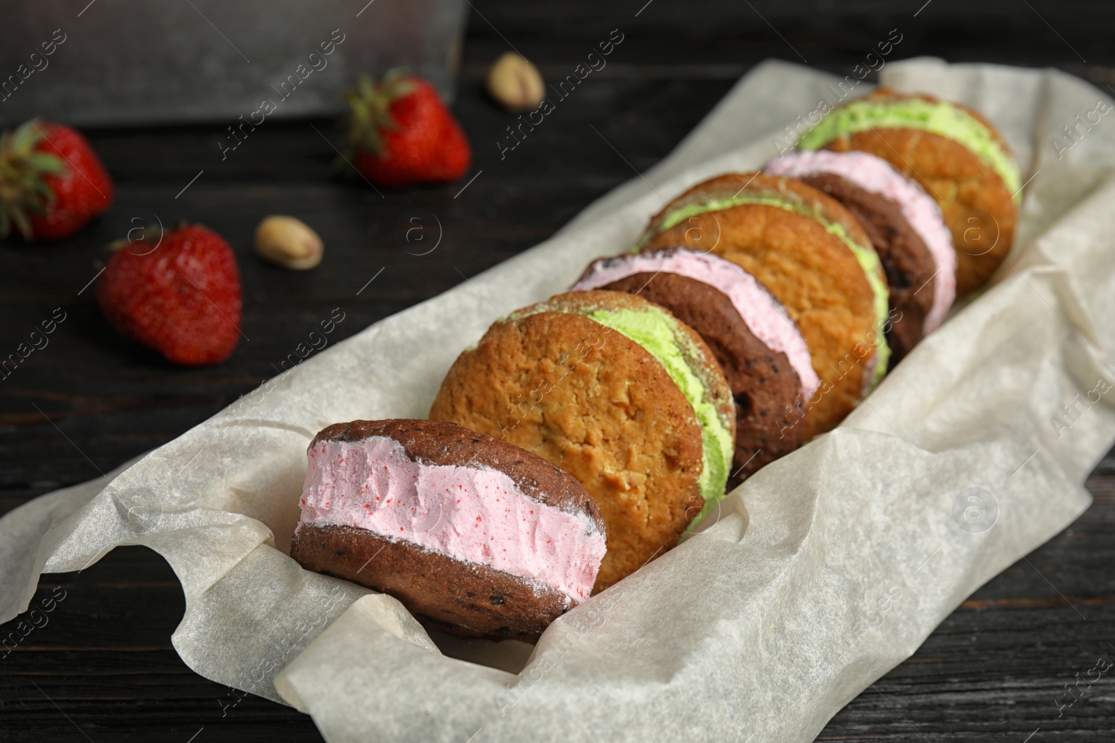 Photo of Different sweet delicious ice cream cookie sandwiches served on table