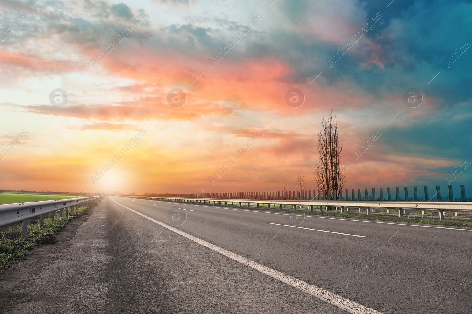 Image of Road trip. Beautiful view of asphalt highway at sunset 