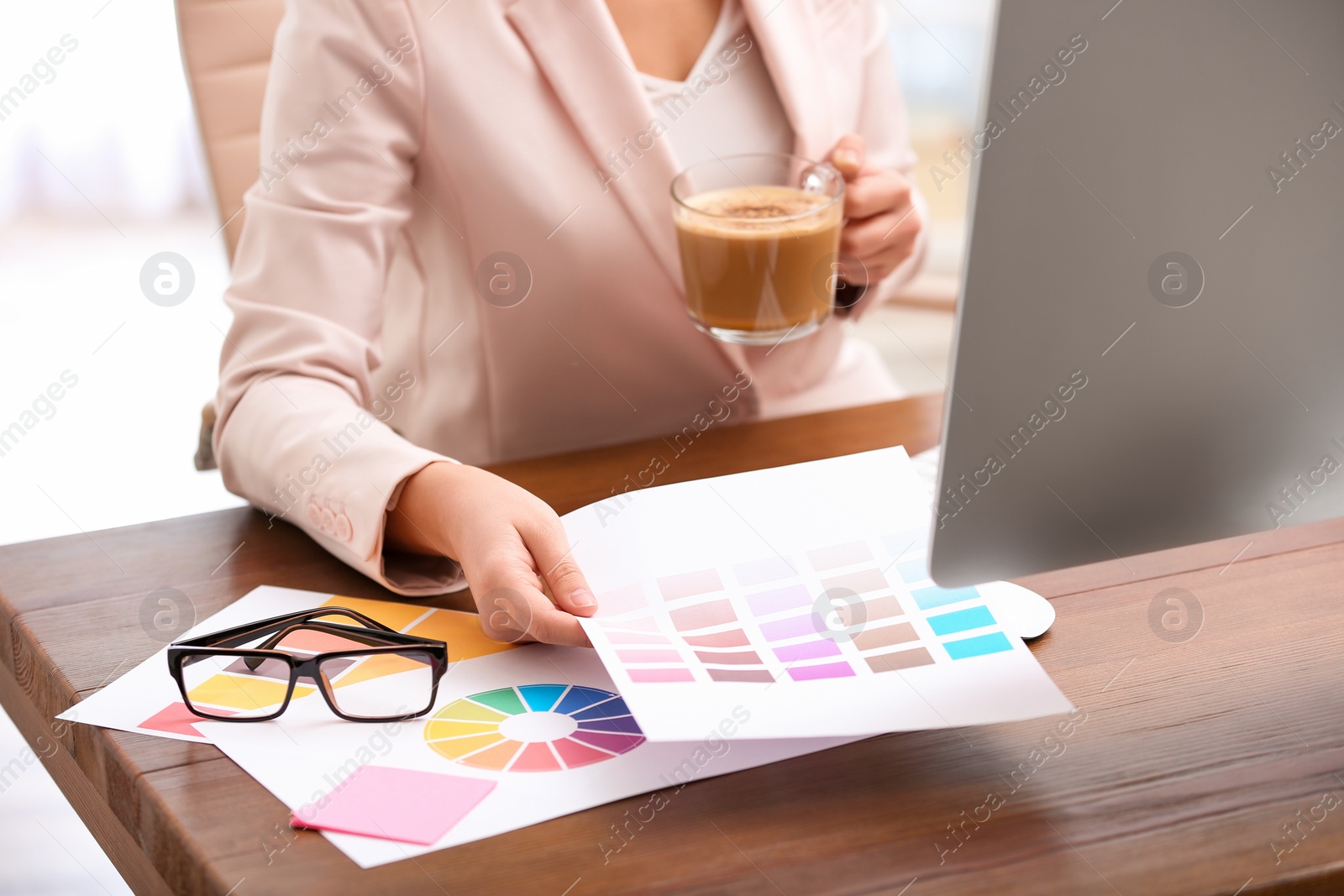 Photo of Female designer working at desk in office, closeup