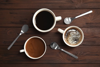 Flat lay composition with cups of coffee on wooden background. Food photography