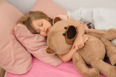 Photo of Little girl snoring while sleeping in bed