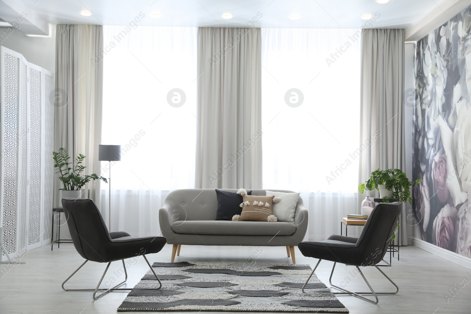 Photo of Modern living room interior with comfortable sofa and armchairs