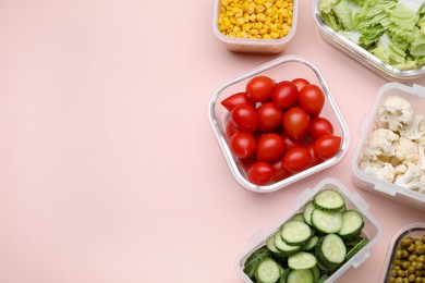 Photo of Plastic and glass containers with different fresh products on light pink background, flat lay. Space for text