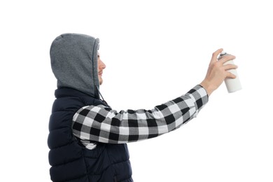 Man holding can of spray paint on white background