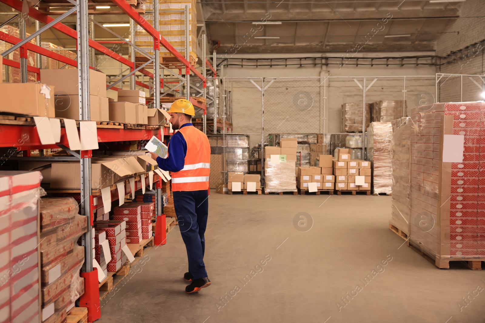 Image of Man with tablet working at warehouse. Logistics center