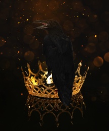 Image of Fantasy world. Black crow sitting on golden crown, bokeh effect