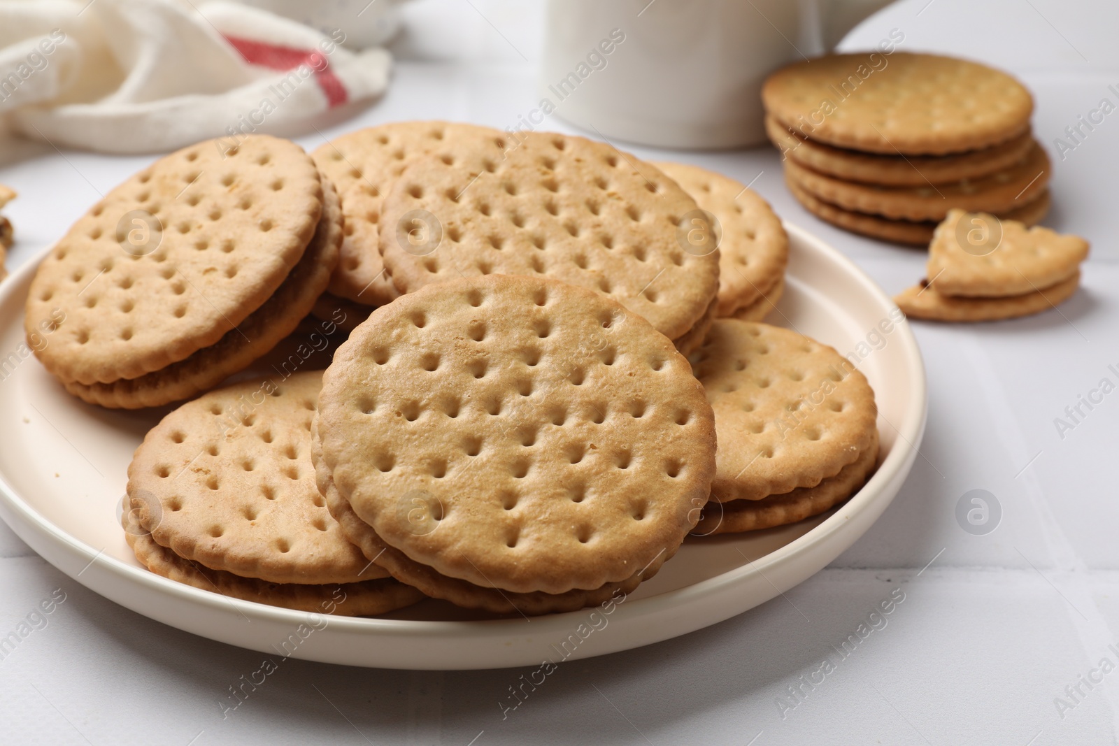 Photo of Tasty sandwich cookies on white table, closeup