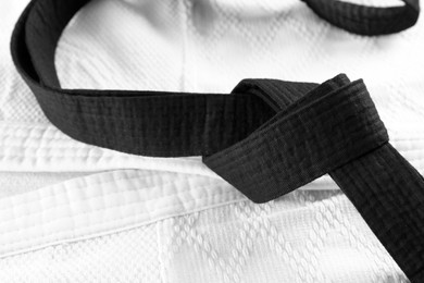 Photo of Black belt on white kimono, closeup view