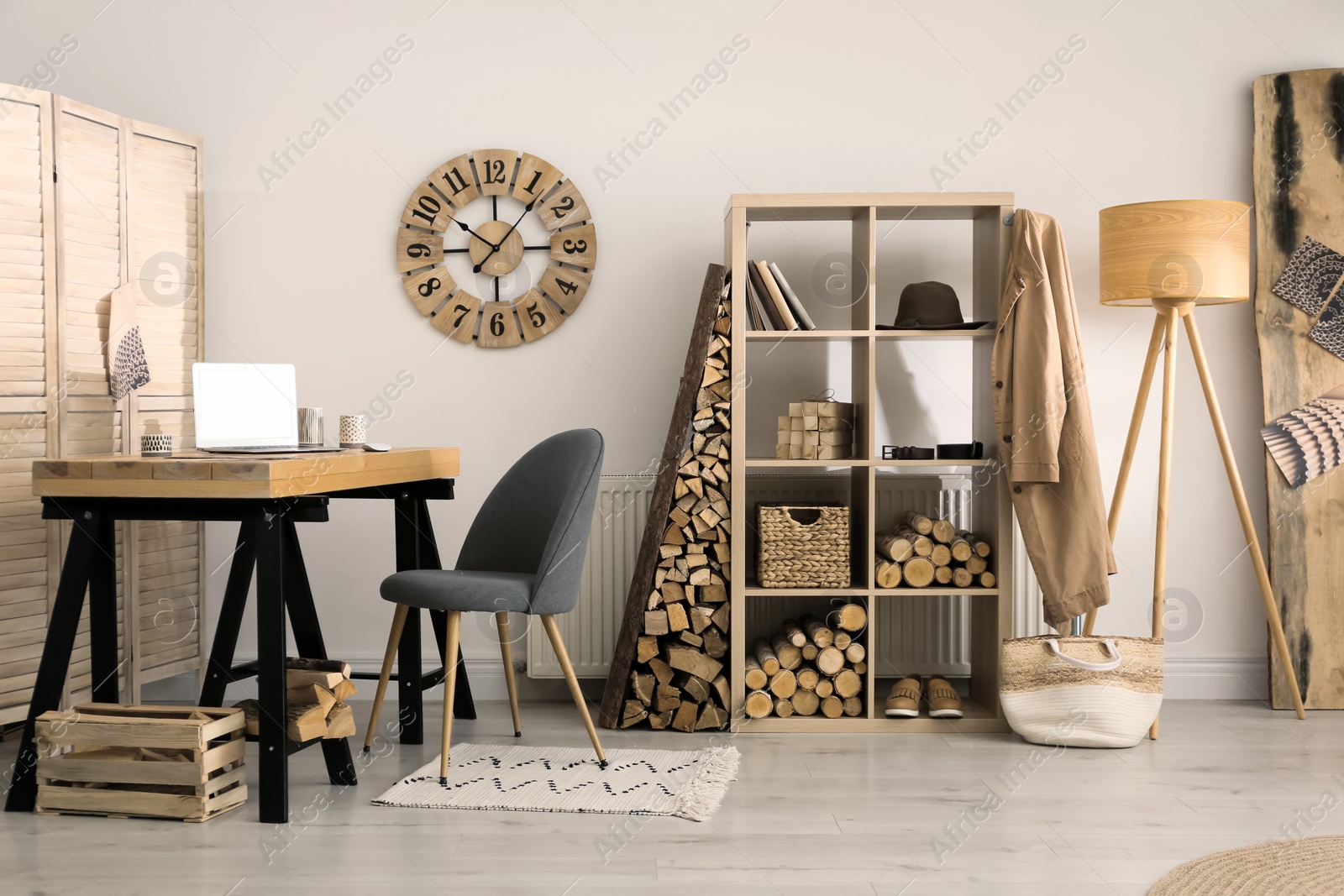 Photo of Stylish room interior with firewood as decorative element