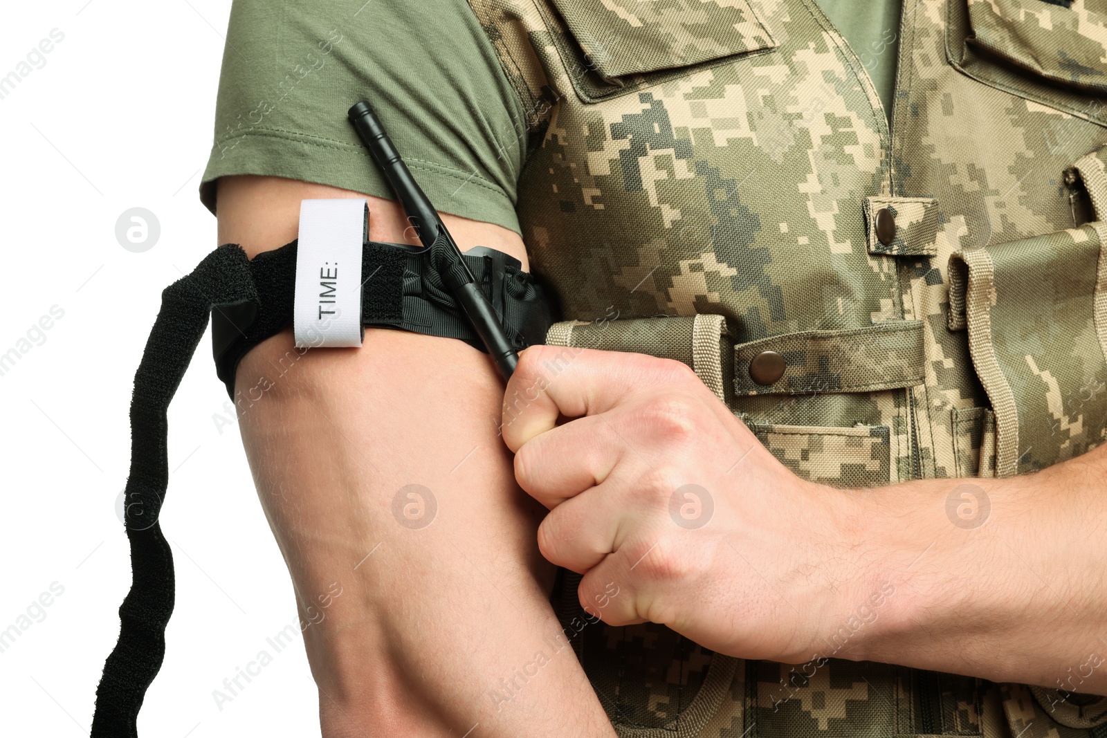 Photo of Soldier in military uniform applying medical tourniquet on arm against white background, closeup