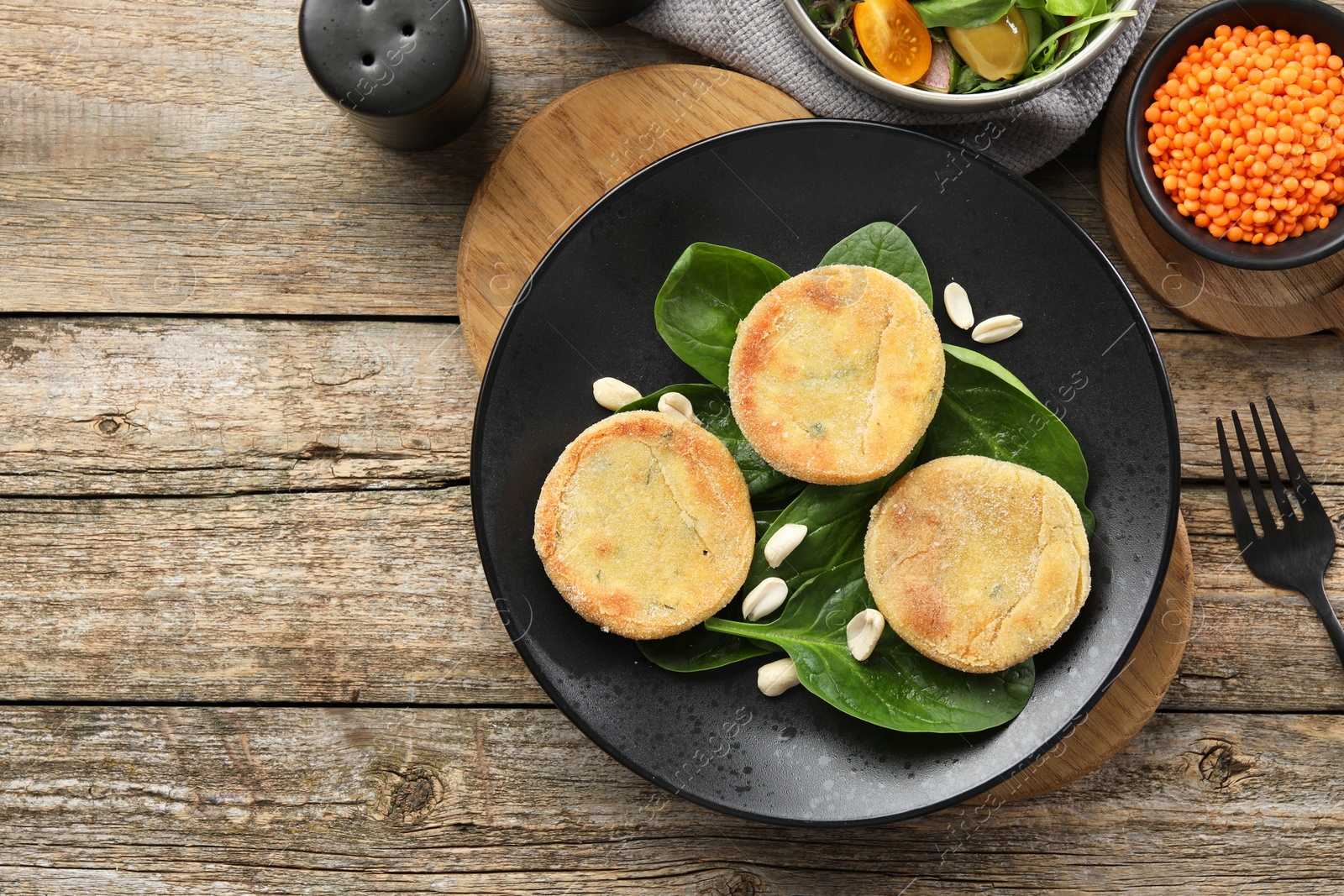 Photo of Healthy food high in vegetable fats and spices on wooden table, flat lay. Space for text